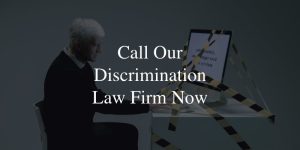 Call Our Discrimination Law Firm Now -older gentleman on the computer with caution tape around it